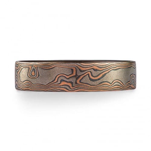 flat profile mokume gane ring made in a woodgrain pattern, with red gold, palladium and oxidized silver