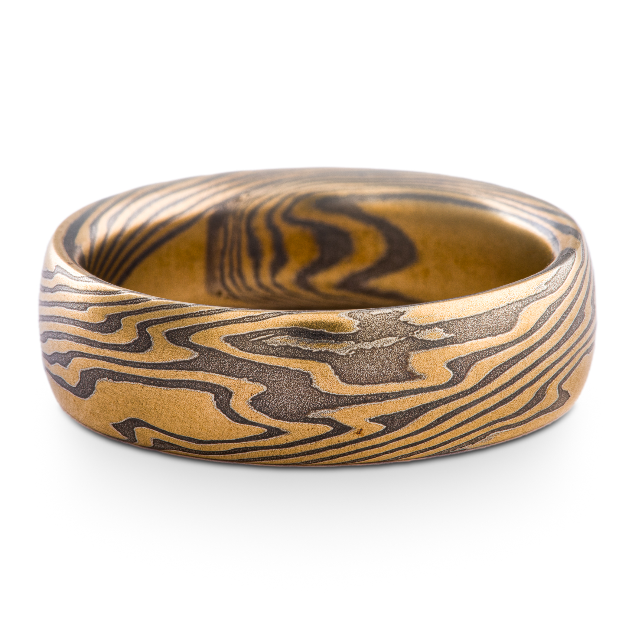 Mokume gane twist pattern ring made with yellow gold and oxidized silver, with a very low domed profile.
